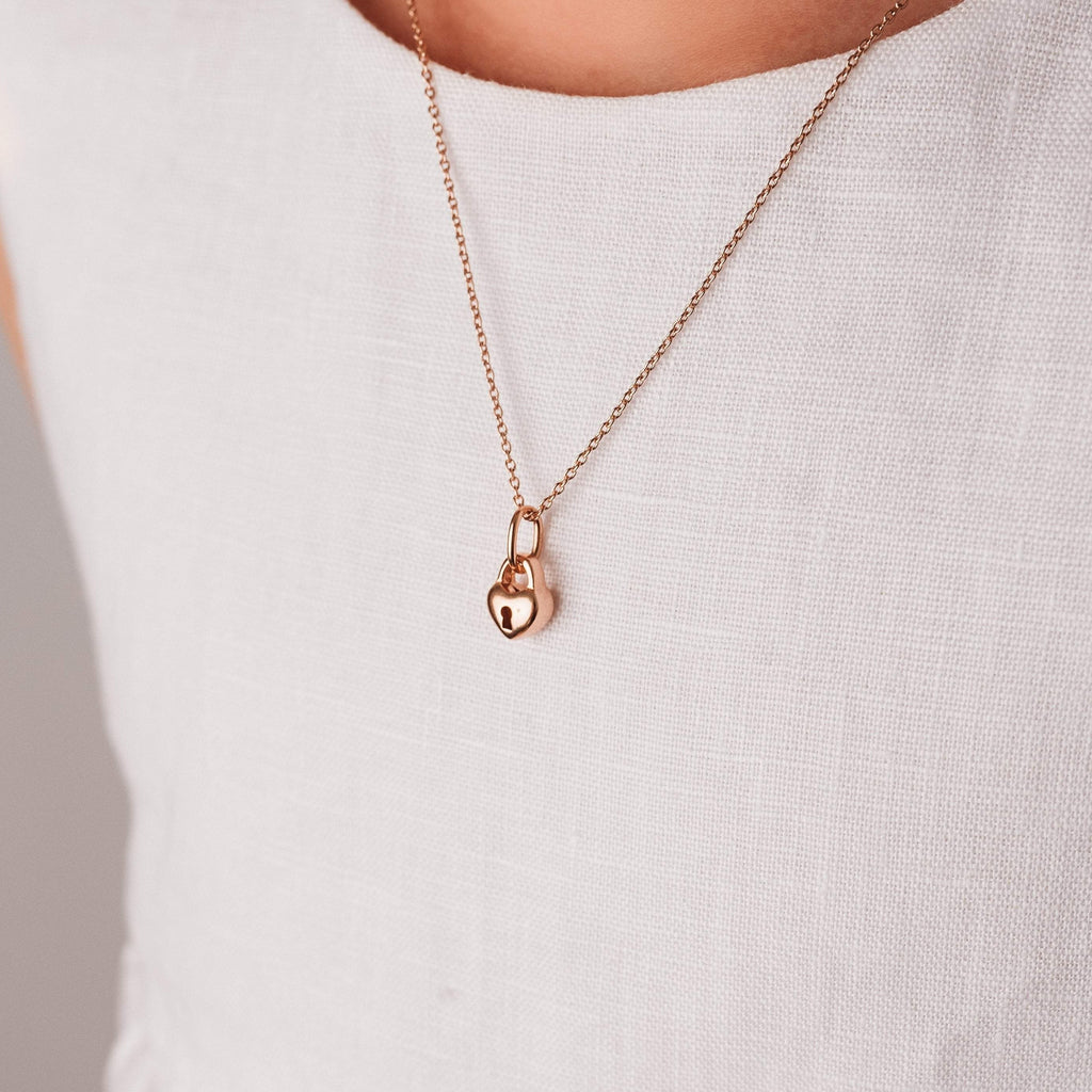 Love Heart Lock Necklace on Rose Gold Chain worn by a tween girl in a white dress